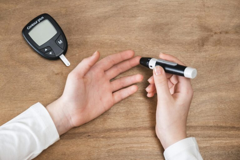 Diabetes checking blood sugar level. Child using lancelet and glucometer