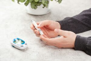 man hands using lancet on finger to check blood sugar ketones level glucose meter. medicine diabetes