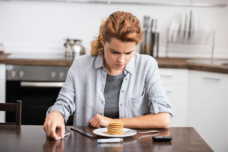 woman with diabetes looking at sweet pancakes