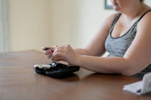 Young woman with gestational diabetes testing blood glucose levels