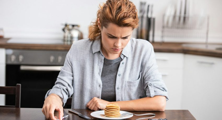 woman with diabetes looking at sweet pancakes