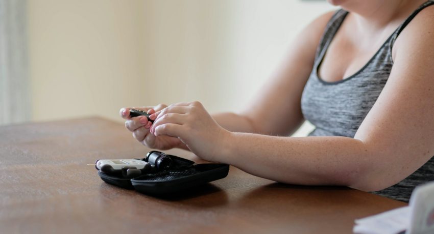 Young woman with gestational diabetes testing blood glucose levels